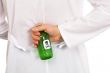 Hand with green bottle