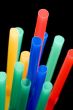 drinking straws on black close up