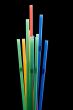 drinking straws on black closeup