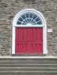 red door on a stone wall
