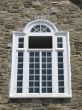 white window and stone wall