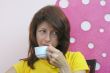 Young woman drinking coffee in cafe