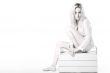 Woman sitting on a wooden case