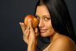 woman`s keeping the raw apple