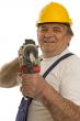 Worker with drilling machine and safety helmet
