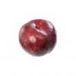 A red plum lying on a table