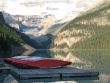 canoes by a lake and mountains