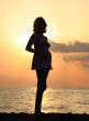 Pregnant woman at sunset