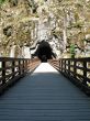 long, old wooden bridge going into a tunnel