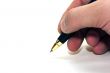 Hand and pen on the white paper