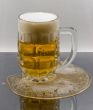 Light beer in the mug on wet surface