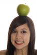 Teenager with apple at the head