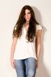 Pretty young girl standing against a wall