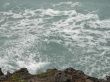 wave crashing on a cliff