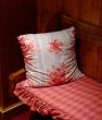 Red pillow kept on a wooden bench