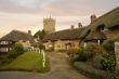 Idyllic hamlet of thatched cottages at sunset