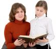 Woman and girl reads the book