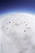 Skydiving Formation Above the Clouds