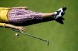 female golfer resting on the green
