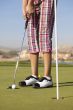  young golfer on putting green