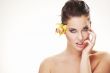 happy young woman with yellow flower