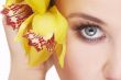happy young woman with yellow flower