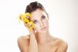 happy young woman with yellow flower