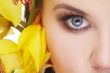 happy young woman with yellow flower