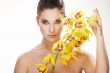 happy young woman with yellow flower