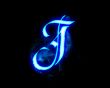 Blue flame magic font over black background. Letter J
