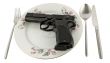 Pistol in a plate on the served table