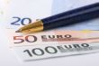 Euro banknotes and pen
