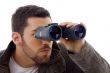 side view of man looking through binoculars