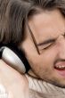 male listening to music on headphone