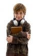 student with books looking at camera