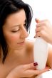 woman posing with lotion bottle