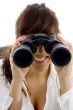 smiling businesswoman looking through binoculars