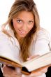 smiling student with book looking at camera