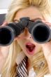 shocked female looking through binocular