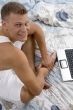 side pose of male with laptop