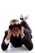 executive lying on floor and using binoculars