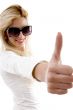 side view of smiling model with thumbs up