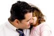 father cuddling his daughter