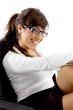 side view of smiling woman sitting on chair