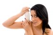 female holding lotion bottle