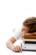 half length view of boy sleeping on books