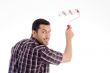 male looking backward while using roller brush