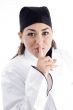 young beautiful chef shushing with finger