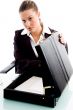 businesswoman putting document in briefcase