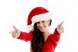 woman with christmas hat pointing with both hands